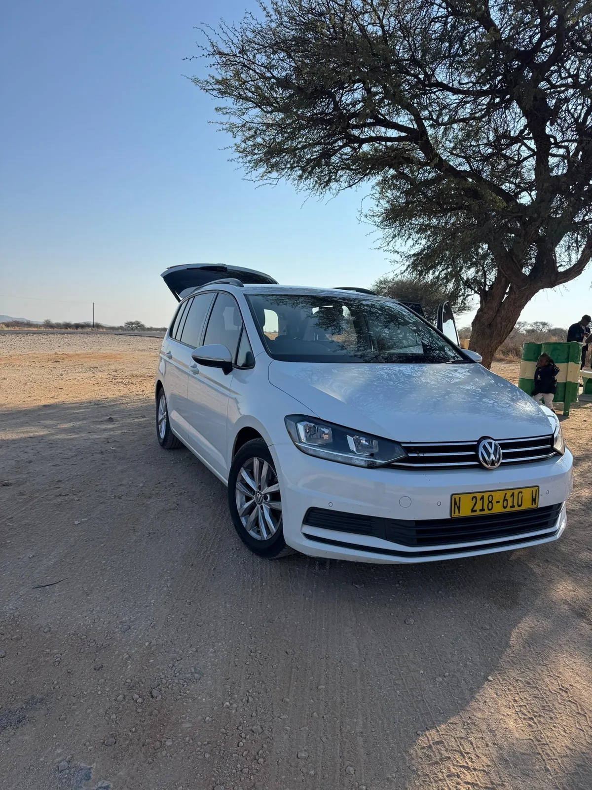 White Volkswagen Touran rental vehicle parked on a driveway in Oshakati, Namibia